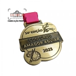 MEDALHA CONCURSO - Medalha em metal com relevo formato recortado com fita e banho bronze. Fbrica de medalhas personalizadas para eventos. Peas sofisticadas para premiaes especiais.
